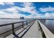 Scenic view of community pier on the water with cloudy blue skies in the background at 925 N Halifax Ave # 1105, Daytona Beach, FL 32118