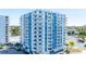 Exterior view of a condo with balconies, a pool, and palm trees, offering picturesque city views at 925 N Halifax Ave # 1105, Daytona Beach, FL 32118