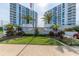 Condo buildings with manicured lawns and palm trees on a sunny day at 925 N Halifax Ave # 1105, Daytona Beach, FL 32118