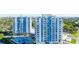 Aerial view showcases condo buildings with balconies, a large pool, manicured landscaping, and waterfront views at 925 N Halifax Ave # 1105, Daytona Beach, FL 32118