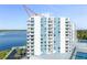 Aerial view of a blue and white condo building with balconies, water views, and rooftop amenities at 925 N Halifax Ave # 1105, Daytona Beach, FL 32118