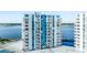 Exterior shot of a high-rise condo building with blue and white paint and balconies, overlooking a bay at 925 N Halifax Ave # 1105, Daytona Beach, FL 32118