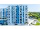Condo building with balconies and a swimming pool, offering a view of the surrounding neighborhood at 925 N Halifax Ave # 1105, Daytona Beach, FL 32118