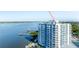 Condo building with balconies offering stunning waterfront views, complemented by tennis courts and lush landscaping at 925 N Halifax Ave # 1105, Daytona Beach, FL 32118