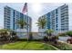 Beautiful high-rise condos with balconies, palm trees, manicured lawn and an American flag waving proudly at 925 N Halifax Ave # 1105, Daytona Beach, FL 32118