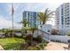 Beautiful grounds and flag pole near a condo building with palm trees on a sunny day at 925 N Halifax Ave # 1105, Daytona Beach, FL 32118
