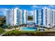 Condo exterior view showcasing balconies and outdoor pool with lounge chairs at 925 N Halifax Ave # 1105, Daytona Beach, FL 32118