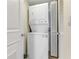 Efficient laundry area with a stacked washer and dryer unit and a storage closet for convenience at 925 N Halifax Ave # 1105, Daytona Beach, FL 32118