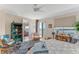 This bedroom has a ceiling fan, blue rug, and access to a balcony at 925 N Halifax Ave # 1105, Daytona Beach, FL 32118
