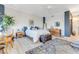 This main bedroom features a blue accent wall, a chest, and wood floors at 925 N Halifax Ave # 1105, Daytona Beach, FL 32118