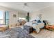 This main bedroom features a blue rug, a chest, and a ceiling fan at 925 N Halifax Ave # 1105, Daytona Beach, FL 32118