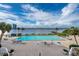 Large, inviting pool with waterfront views, surrounded by lounge chairs and tropical landscaping at 925 N Halifax Ave # 1105, Daytona Beach, FL 32118