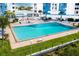 Inviting pool area surrounded by lounge chairs, tropical trees, and manicured landscaping at 925 N Halifax Ave # 1105, Daytona Beach, FL 32118