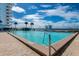 Large outdoor pool with blue water, deck surround, metal safety railing and water views at 925 N Halifax Ave # 1105, Daytona Beach, FL 32118