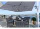 Outdoor dining set for four with water views on roof top deck. (Virtually Staged) at 925 N Halifax Ave # 1105, Daytona Beach, FL 32118