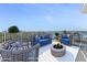 Outdoor seating arrangement with a fire pit on the rooftop (Virtually Staged) at 925 N Halifax Ave # 1105, Daytona Beach, FL 32118