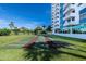 Community shuffleboard courts with manicured lawns in front of a condo building on a bright day at 925 N Halifax Ave # 1105, Daytona Beach, FL 32118