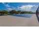 Spacious community tennis court with a fence surround and mature landscaping in the background at 925 N Halifax Ave # 1105, Daytona Beach, FL 32118