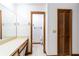 Bathroom featuring a wood vanity with a wide mirror and adjoining toilet stall at 230 Katrina St # 230, De Leon Springs, FL 32130