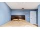 Bedroom features blue walls, wood headboard, and a white door at 230 Katrina St # 230, De Leon Springs, FL 32130
