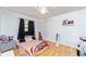 Bright bedroom with wood floors, a ceiling fan, and a window with dark curtains at 230 Katrina St # 230, De Leon Springs, FL 32130