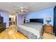 Bedroom boasts wood floors, ceiling fan, ensuite bathroom, and queen sized bed at 230 Katrina St # 230, De Leon Springs, FL 32130