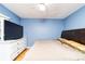 Bedroom with blue walls, wood floors, dresser and bed at 230 Katrina St # 230, De Leon Springs, FL 32130