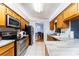 Well-equipped kitchen showcasing stainless steel appliances and a view into the dining area at 230 Katrina St # 230, De Leon Springs, FL 32130