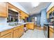 Charming kitchen with light wood cabinets, white countertops, and stainless steel appliances at 230 Katrina St # 230, De Leon Springs, FL 32130