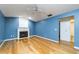 Living room with wood floors, fireplace, vaulted ceilings, and doorway to the bathroom at 230 Katrina St # 230, De Leon Springs, FL 32130