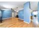 Open-concept living room and dining room with wood floors at 230 Katrina St # 230, De Leon Springs, FL 32130