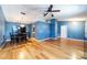 Open-concept living and dining area with hardwood floors, and a modern ceiling fan at 230 Katrina St # 230, De Leon Springs, FL 32130