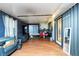 Living room featuring grey sofa, hardwood floors, and view of backyard through sliding glass door at 230 Katrina St # 230, De Leon Springs, FL 32130