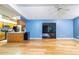 Living room with hardwood floors, ceiling fan, blue walls, and sliding doors to the backyard at 230 Katrina St # 230, De Leon Springs, FL 32130