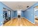 Spacious living room with wood floors, fireplace, and sliding glass door at 230 Katrina St # 230, De Leon Springs, FL 32130