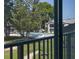 View from balcony looking at community pool and manicured grounds with mature trees at 1 Tomoka Oaks Blvd # 102, Ormond Beach, FL 32174