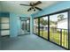 Spacious blue bedroom featuring sliding glass doors to the outside and mirrored closet doors at 1 Tomoka Oaks Blvd # 102, Ormond Beach, FL 32174