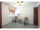Cozy bedroom with neutral carpet, lighted ceiling fan, and two chairs for relaxing by the window at 1 Tomoka Oaks Blvd # 102, Ormond Beach, FL 32174