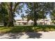 The property features multiple residences with covered parking and mature trees at 1 Tomoka Oaks Blvd # 102, Ormond Beach, FL 32174