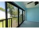 Screened lanai offers a view of the outdoors, with a glimpse of a community pool at 1 Tomoka Oaks Blvd # 102, Ormond Beach, FL 32174