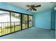 Spacious lanai with full view through sliding glass doors; blue carpet complements the blue walls at 1 Tomoka Oaks Blvd # 102, Ormond Beach, FL 32174
