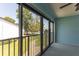 Enclosed lanai featuring sliding glass doors and views of the community pool and green space at 1 Tomoka Oaks Blvd # 102, Ormond Beach, FL 32174