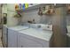 Practical laundry room featuring a washing machine and dryer with upper shelf storage at 1 Tomoka Oaks Blvd # 102, Ormond Beach, FL 32174