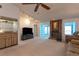 Spacious living room with fireplace, ceiling fan, and wet bar, great for entertaining at 1 Tomoka Oaks Blvd # 102, Ormond Beach, FL 32174
