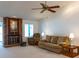 Cozy living room with a brick fireplace, plush seating, and plenty of natural light at 1 Tomoka Oaks Blvd # 102, Ormond Beach, FL 32174
