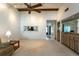 Open floor plan featuring a ceiling fan, wet bar, and a convenient pass-through to the kitchen at 1 Tomoka Oaks Blvd # 102, Ormond Beach, FL 32174