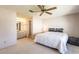 Bright main bedroom featuring an ensuite bathroom and a comfortable queen-sized bed at 1 Tomoka Oaks Blvd # 102, Ormond Beach, FL 32174