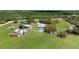 An expansive aerial shot showcases the home, pond, outbuildings, and surrounding acreage at 1060 Still Rd, Pierson, FL 32180
