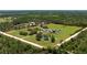 Expansive property featuring a well-defined boundary, multiple structures, and a tranquil pond at 1060 Still Rd, Pierson, FL 32180