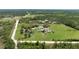 Lush acreage featuring a primary residence, pond, outbuildings, and verdant pastures at 1060 Still Rd, Pierson, FL 32180